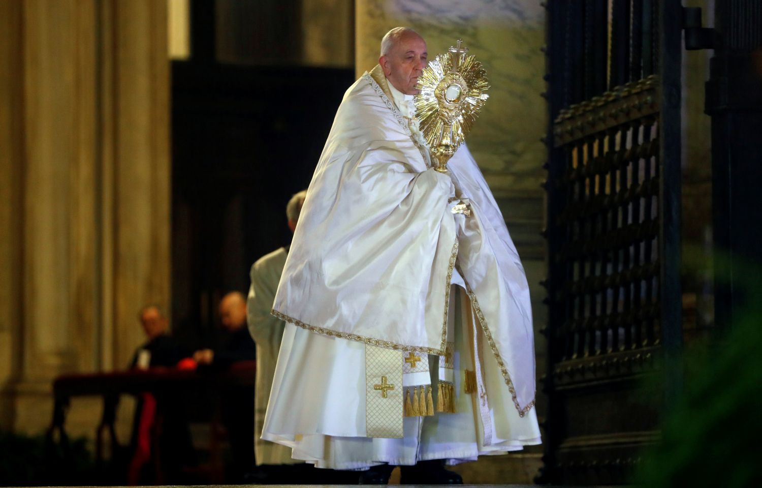 Pope Francis blesses the City of Rome and the World while holding the Holy Eucharist on the steps of St. Peter's Basilica.