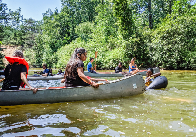 youth in canoe on river