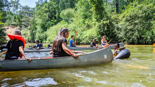youth in canoe on river