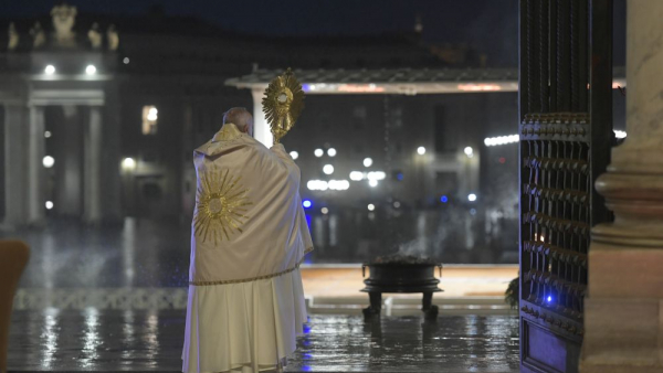 Pope Francis blesses the City of Rome and the World, holding the monstrance on the steps of St. Peter's Basilica in Rome.