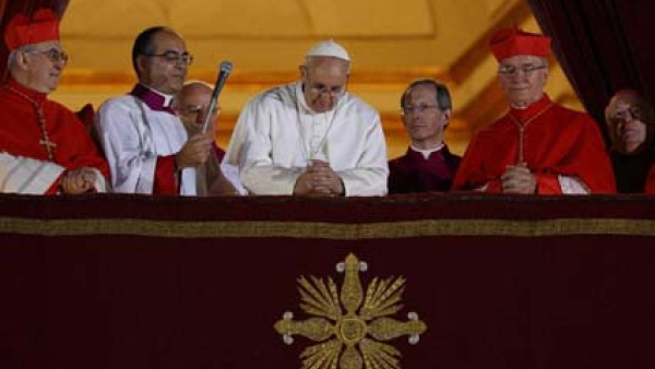 Pope Francis bows his head in prayer during his election night appearance