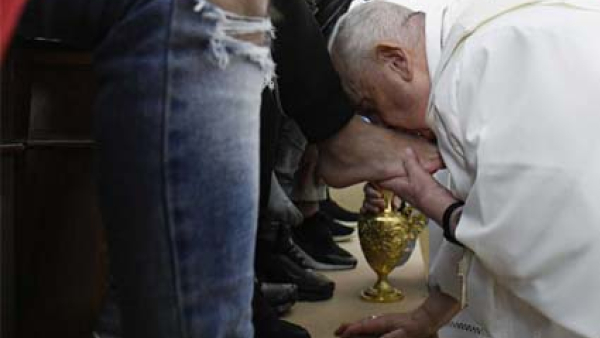 Pope Francis kisses the foot of an inmate after washing it during the Holy Thursday Mass of the Lord's Supper at Rome's Casal del Marmo prison for minors, April 6, 2023. 