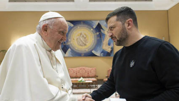 Pope Francis and Ukrainian President Volodymyr Zelenskyy shake hands