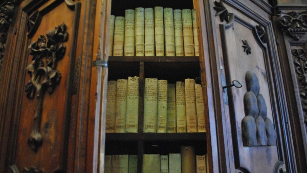 Old volumes are pictured in a wooden cabinet in the Vatican Apostolic Archives 