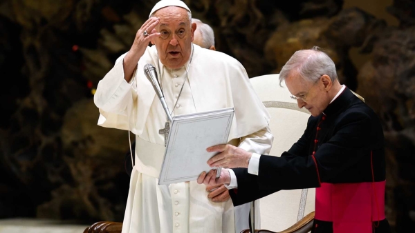 Pope Francis delivers his blessing to visitors in the Paul VI Audience Hall 