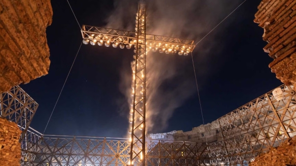 A large illuminated cross is displayed before the start of the Way of the Cross outside the Colosseum in Rome April 18, 2025.