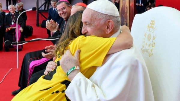The late Pope Francis hugs a young volunteer during the 37th World Youth Day in Lisbon, Portugal, on August 6, 2023 