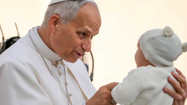 Pope Leo XIV greets a child