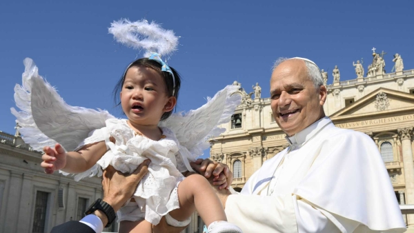 Pope Leo XIV greets a child 