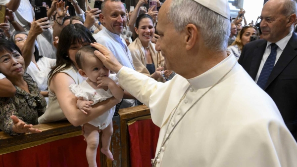 Pope Leo XIV greets a baby and family 