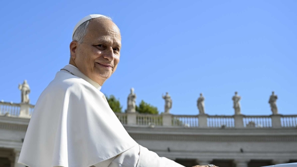 Pope Leo XIV smiles as he greets visitors