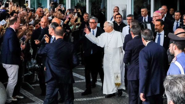 Pope Leo XIV waves to well-wishers as he walks out of Rome’s Gemelli hospital Oct. 17